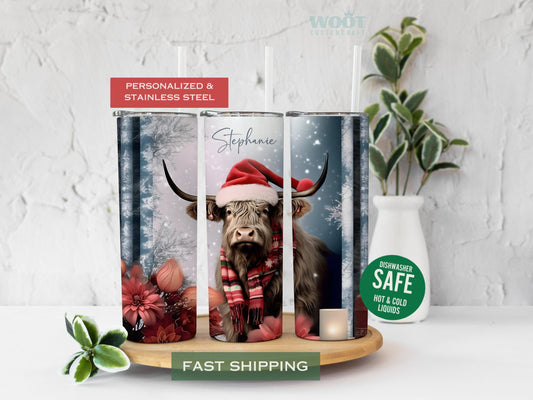 Three tumblers are showing all sides of a Christmas Highland Cow Tumbler. It is snowing. There is a cow and flowers, snow, and a personalized name.