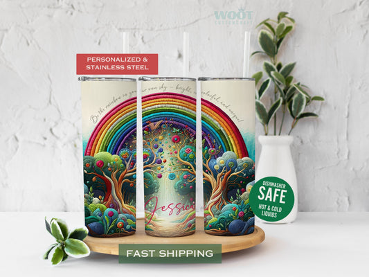 Three tumblers are showing all sides of a personalized rainbow tumbler with a customized name on the tumbler button.