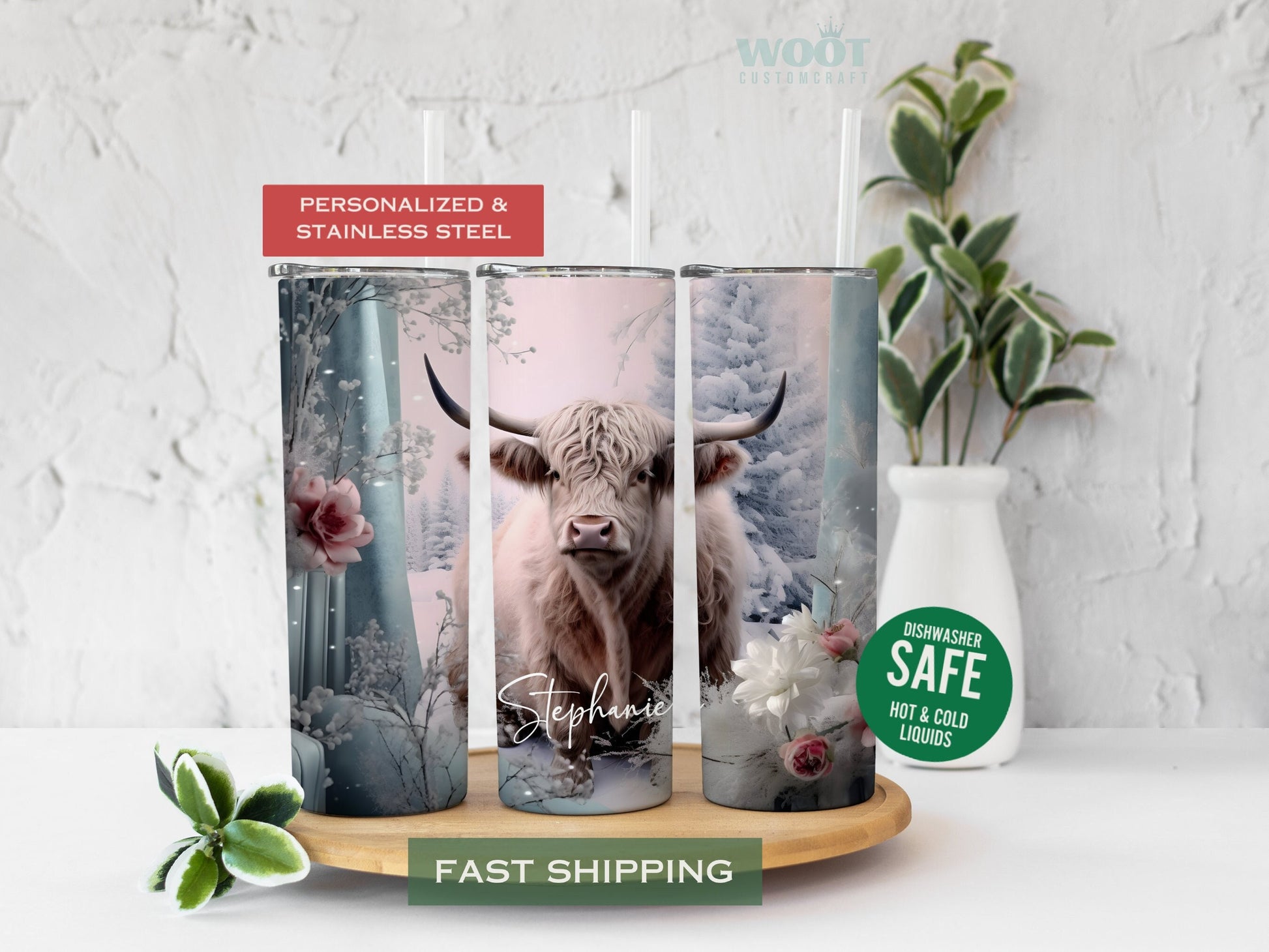 Three tumblers are showing all sides of a Winter Highland Cow Tumbler. It is snowing. There is a cow and flowers, snow, and a personalized name.