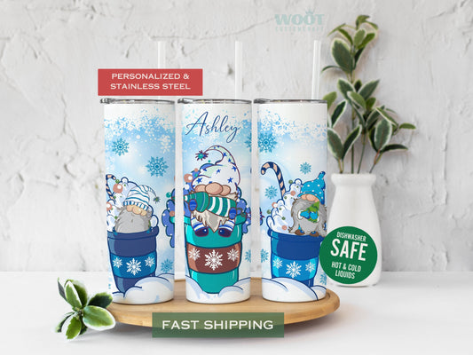 Three tumblers are showing all sides of a Merry Christmas Tumbler. Snowy scene with Snowflakes. Three gnomes and the personalized name in the top of the tumbler.