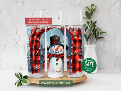 Three tumblers are showing all sides of a Christmas Winter Tumbler. A snowy scene with a Snowman in the center, some Christmas trees, and a personalized name on the button of the tumbler.