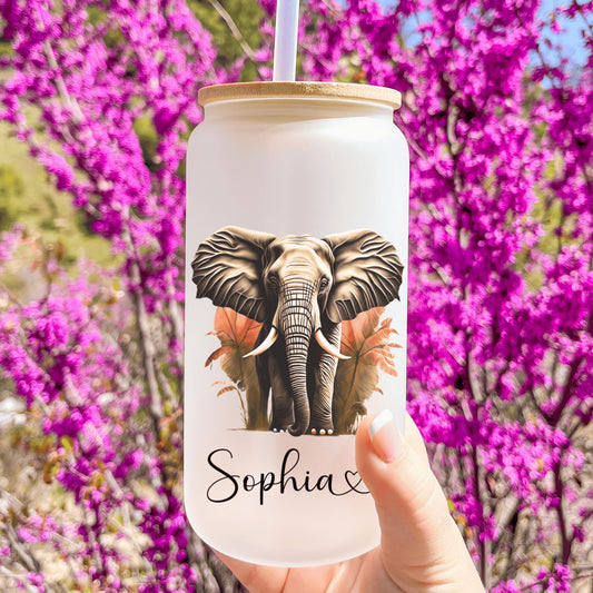 a hand holding a cup with a picture of an elephant on it