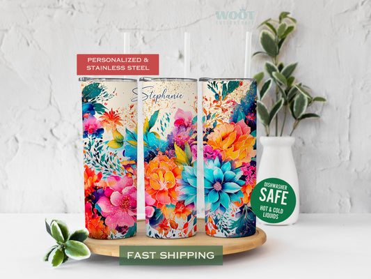 Three tumblers represent the rotating parts of a floral tumbler. There are spring flowers of different colors. There are blues, oranges, pink flowers, and glitter. There is a space at the top of the tumbler to add the name as a personalization.