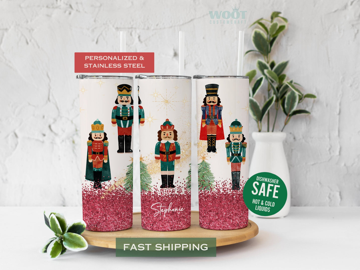Three tumblers are showing all sides of a Christmas Holiday Tumbler. There are five Nutcracker dolls, two Christmas trees, and Christmas red and gold glitter, a personalized name on the button of the tumbler.